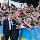 Ukrainian President Volodymyr Zelensky poses for selfies with voters.