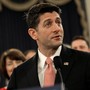 House Speaker Paul Ryan holds a sample postcard-size tax form.