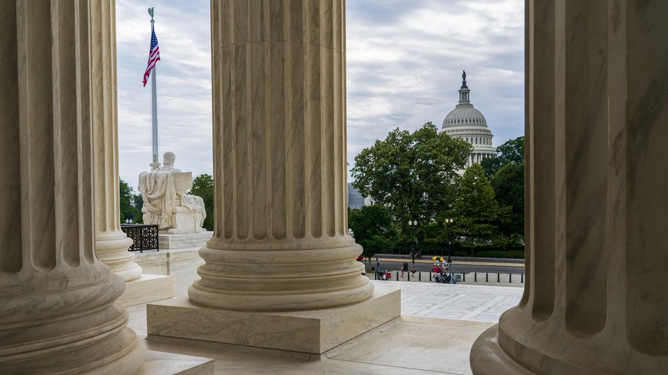 The Capitol is framed by the columns at the U.S. Supreme Court, in Washington, D.C.