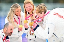 Members of Team USA celebrate on the podium with their gold medals.