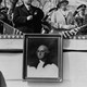 A portrait of George Washington on display during a parade