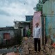 Sahibraj Ramadhar Yadav in front of his house, which collapsed during the monsoon landslide in Panchsheel Chawl, in Vikhroli