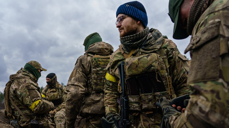Ukrainian soldiers stand ready to defend against Russian forces in Irpin, Ukraine.
