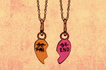 two "Best Friend" necklaces, each with half a heart, hanging side by side with all text except "End" crossed out