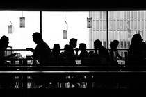 Silhouettes of people sitting in a restaurant