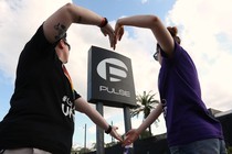 Heather Raleigh and Paige Metelka make a heart shape as they pose during a photo shoot outside Pulse nightclub. 