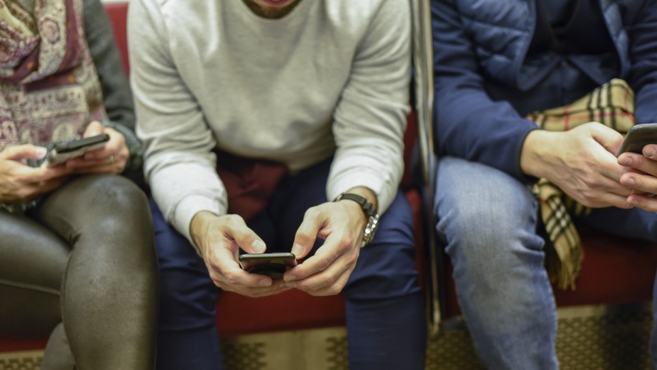 Person on their phone on the subway