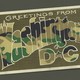 An illustration of a postcard reading "Greetings from Washington DC" colored in a camo pattern