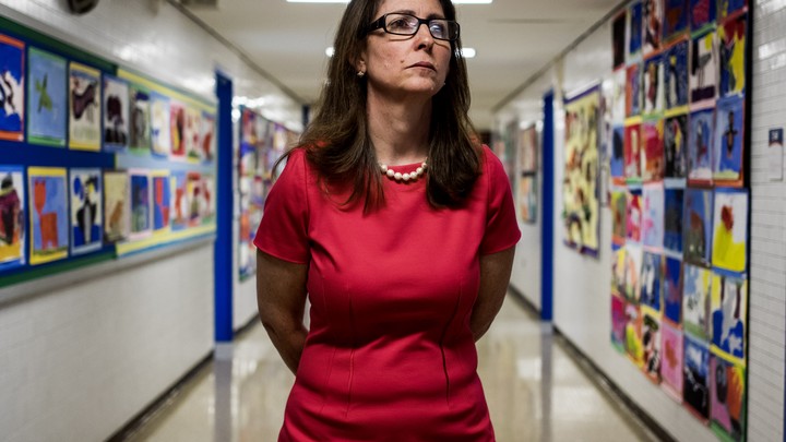 Eva Moskowitz looks sternly into the distance in a hallway in one of Success Academy's Harlem schools.
