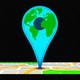 Illustration of a large pin shaped like the Earth on top of a street map