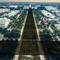 Photo illustration: U.S. Capitol building casting a long "T" shadow down the Mall