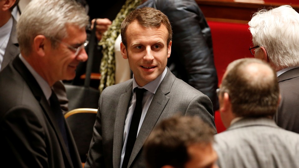 Emmanuel Macron leaves after the government session at the National Assembly in Paris, France, on May 10, 2016.