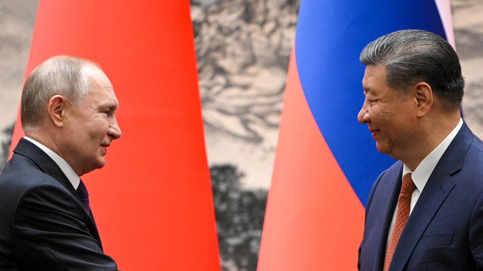 A photo of Russian president Vladimir Putin greeting China's premier, Xi Jinping