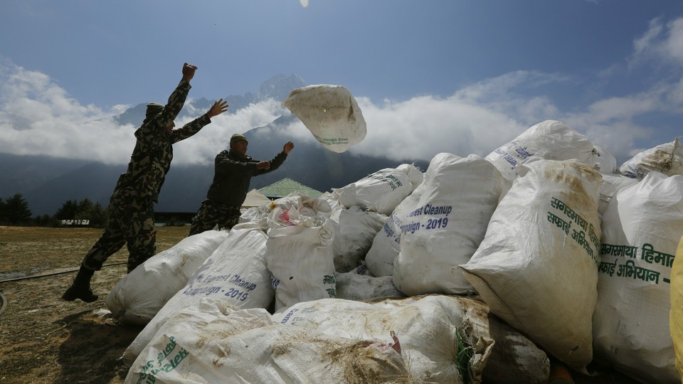 Nepalese men pile up garbage collected from Mount Everest on May 27, 2019