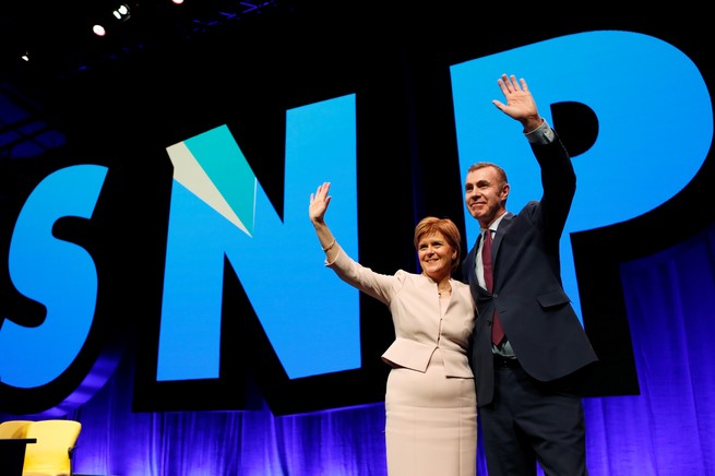 Nicola Sturgeon and Adam Price wave to a crowd at an SNP event.