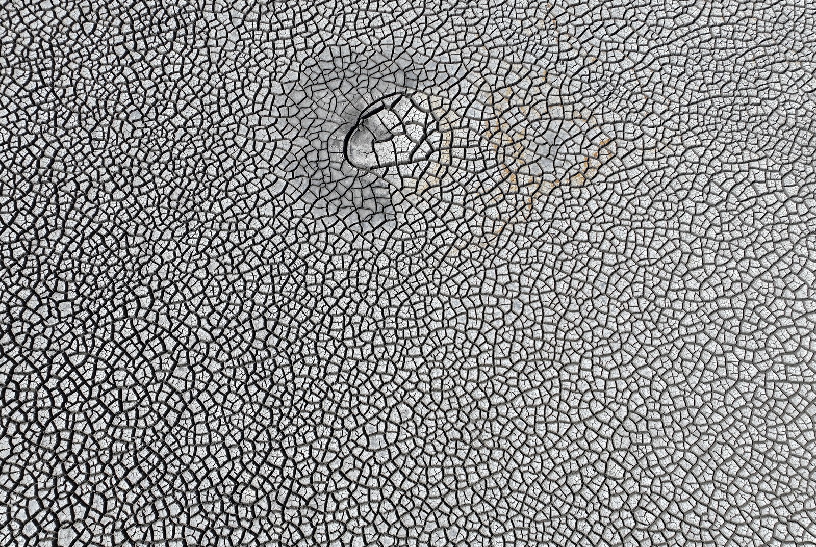 An aerial view of dry, cracked soil