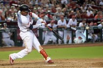 A professional baseball player hits a ball with his bat during the ninth inning. 