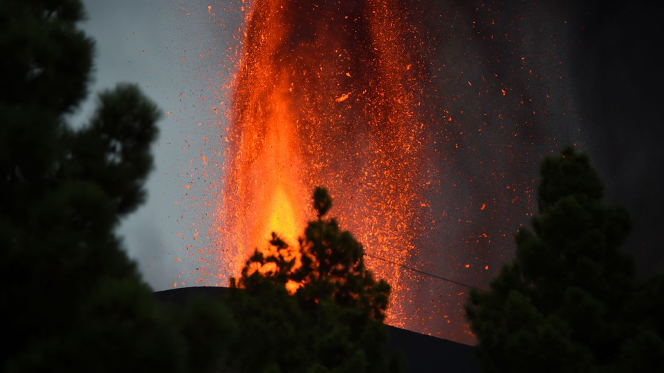 A bright orange burst of lava emerges from the ground