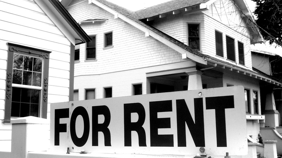 House with a "For Rent" sign