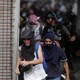 Demonstrators run away from security forces at a rally in Caracas on July 27, 2017. 