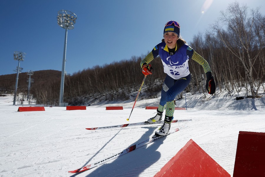 An athlete skis past a turn during a biathlon.