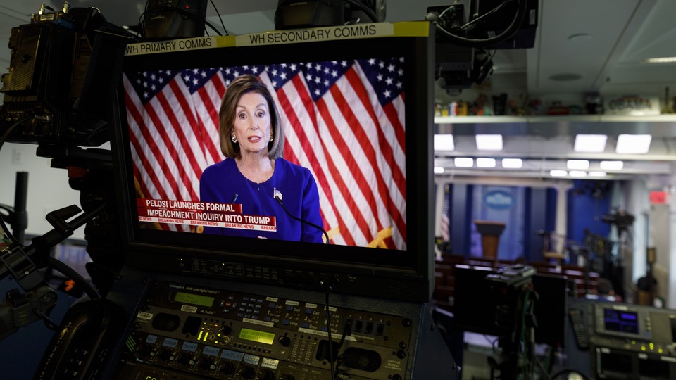 Nancy Pelosi appears on a video screen at the back of the White House press briefing room.