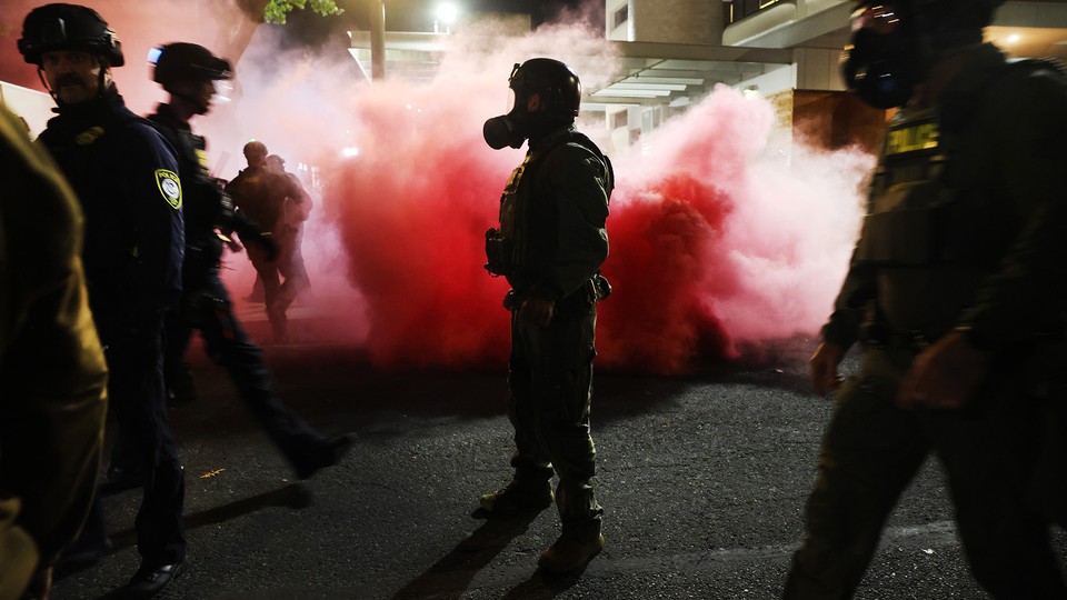 An image of federal agents attempting to keep protesters back outside an ICE facility on October 05, 2025 in Portland, Oregon