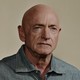 Mark Kelly in front of a tan backdrop