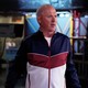 The actor Michael Keaton wears a blue, red, and white-colored tracksuit on the set of 'SNL'