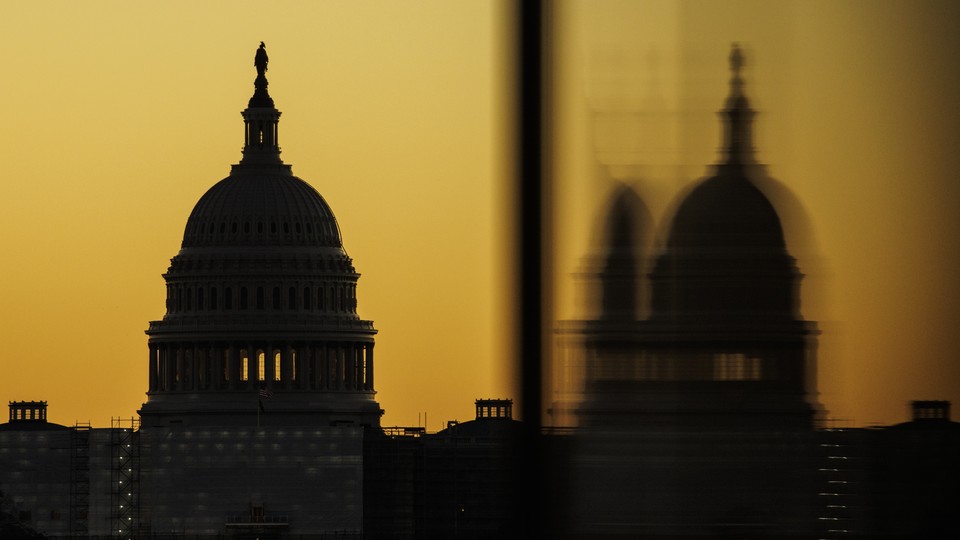 An photograph of the U.S. Capitol against a yellow sky