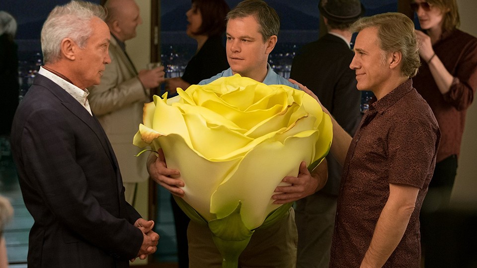Udo Kier, Matt Damon with a big flower, and Christoph Waltz in 'Downsizing'