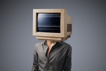 A person whose head has been replaced with a bulky desktop monitor