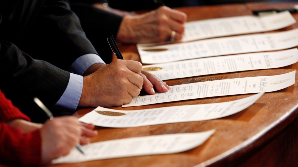 North Carolina Electoral College representatives sign the Certificates of Vote after they all cast their ballots for U.S. President-elect Donald Trump in the State Capitol building in Raleigh, North Carolina, U.S., December 19, 2016.