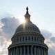 The dome of the U.S. Capitol building with the sun shining through it.