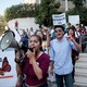 Students are seen with megaphones and signs, protesting.