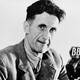 A black-and-white portrait of George Orwell in 1943 in front of a microphone with a "BBC" tag