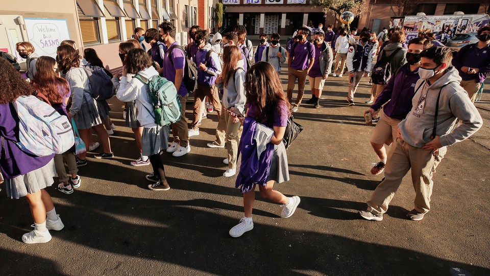 Students queue to enter school building in California.