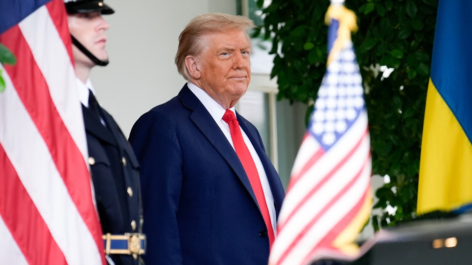 Color photograph of President Donald Trump waiting to greet Ukrainian President Volodymyr Zelensky at the White House.