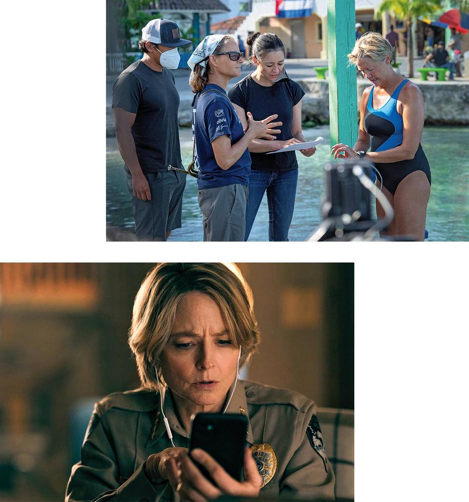2 photos: Foster on dock by water with Bening in swimsuit and 2 other people; still of Foster looking at smartphone
