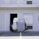 A motel cleaning cart in front of an open door