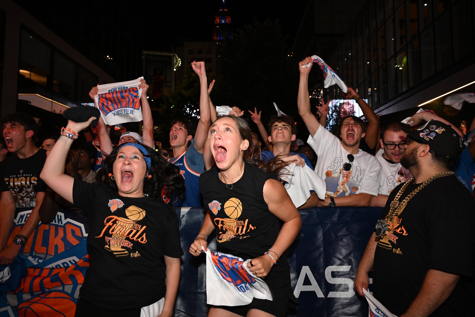 Knicks fans cheer while standing outside of Madison Square Garden.