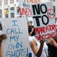Anti-vaccine protesters holding up signs