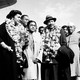 Martin Luther King, Jr. and his wife Coretta, both wearing garlands, are received by admirers after landing at the airport in New Delhi, India, in 1959.