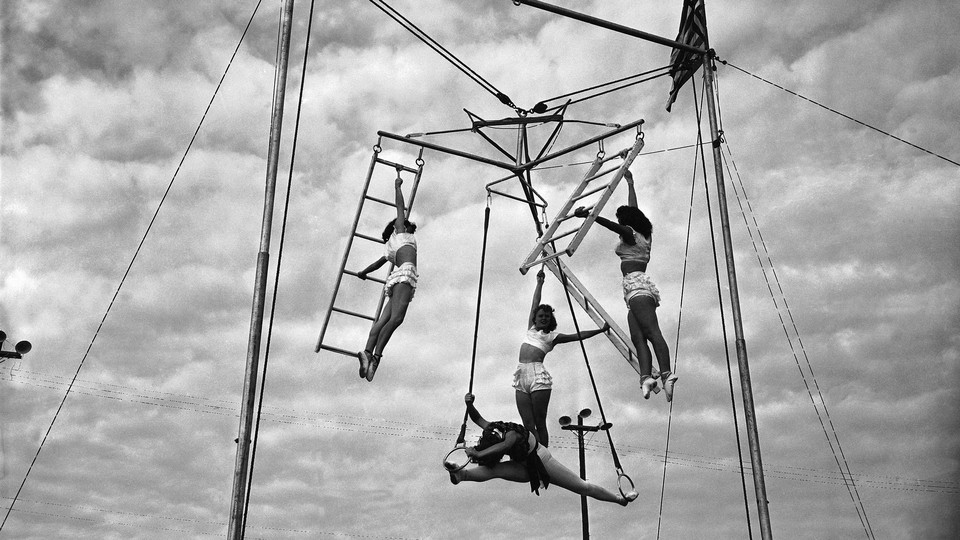black and white photograph of circus women on rings