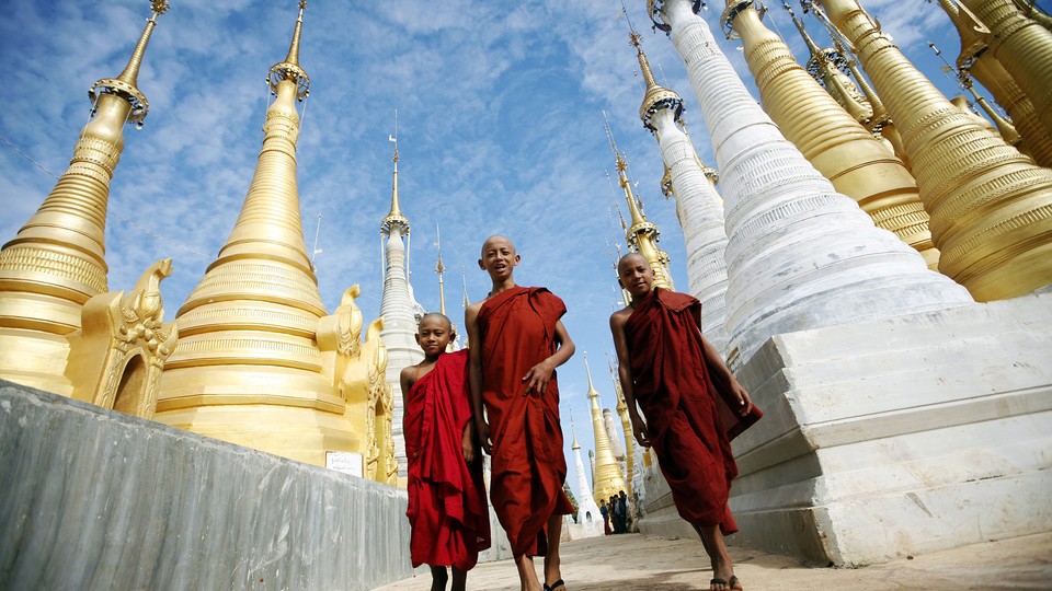 Buddhist monks walk through the Shwe Indein Pagoda near Inle lake in Myanmar.