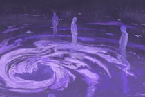 figures stand around a swirling space with a stomach shaped cavity in the middle