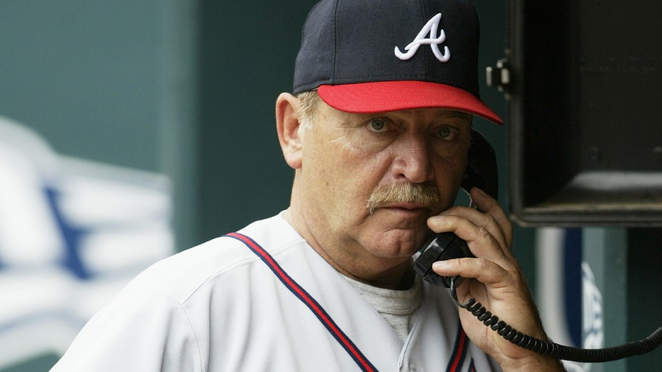 Leo Mazzone using a dugout phone