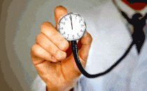 A GIF of a doctor's hand holding up a stethoscope that actually has a ticking clock on its face; the hands are moving around quickly.