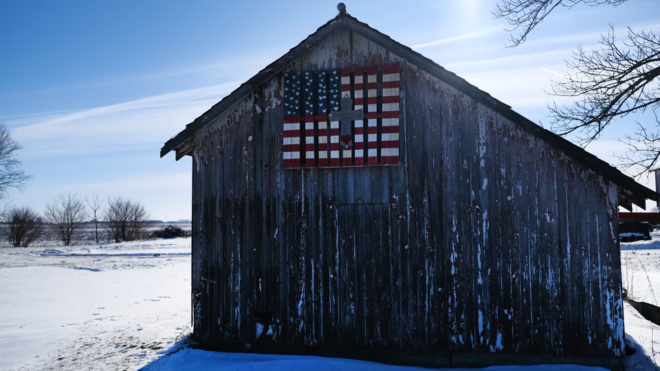 A barn in Iowa decorated with an American flag.