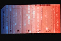 An image of a ballot with zeros and ones going through it.